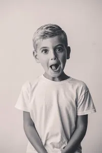 Young boy makes a silly face at the camera during Personality Portrait Photoshoot in Charleston, SC.