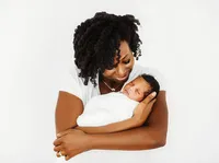 Charleston’s #1 Lifestyle Newborn Photographer, mother holding her infant for Newborn Photoshoot in Charleston, SC.