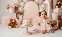 Charleston Cake Smash Photographer- Baby looks into the camera during Cake Smash Photos at Holy City Babies Portrait Studio in Charleston, SC.