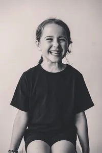 Young girl laughs off camera during Personality Portrait Session in Charleston, SC.