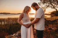 Maternity Photos in Charleston, SC -- Expectant mother poses for Maternity Portraits during Sunset on the Marsh Charleston, SC.