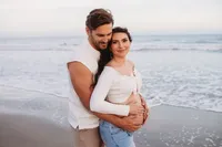 Charleston Beach Maternity Photographer -- Expectant parents pose for Maternity Photos on Folly Beach, SC.