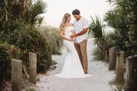 Expectant parents pose together for Maternity Portraits on Folly Beach.