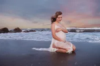 Pregnant mother poses for Maternity Portraits on Folly Beach.
