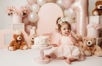 Charleston Cake Smash Photographer- Baby looks into the camera during Cake Smash Photos at Holy City Babies Portrait Studio in Charleston, SC.