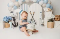 Baby celebrates his first birthday with a Cake Smash Portrait Session at Holy City Babies Portrait Studio in Charleston, SC.