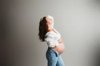 Expectant mother poses for Maternity Photoshoot in Charleston, SC Portrait Studio.