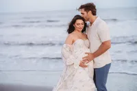 Charleston Beach Maternity Photographer -- Expectant parents pose for Maternity Photos on Folly Beach, SC.