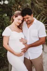 Expectant parents pose together for Maternity Portraits on Folly Beach.