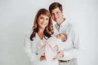 New Parents hold their infant for Newborn Portraits at Holy City Babies Portrait Studio in Charleston, SC.