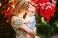 Charleston Baby Milestone Photographer - Mother embraces her baby during Family Photoshoot in Charleston, SC.