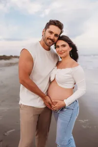 Charleston Beach Maternity Photographer -- Expectant parents pose for Maternity Photos on Folly Beach, SC.
