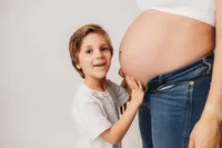 Expectant Mother poses with her toddler for Casual Studio Maternity Portraits in Charleston, South Carolina.