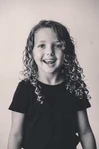 Young girl smiles at the camera during Personality Portrait Photoshoot in Charleston, SC.