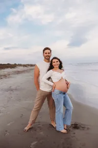 Charleston Beach Maternity Photographer -- Expectant parents pose for Maternity Photos on Folly Beach, SC.