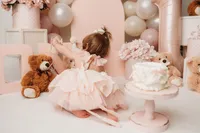 Charleston Cake Smash Photographer- Baby looks into the camera during Cake Smash Photos at Holy City Babies Portrait Studio in Charleston, SC.