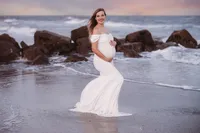Pregnant woman poses for Maternity Portraits on Folly Beach.
