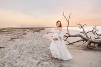 Pregnant woman poses for Maternity Portraits on Folly Beach near Charleston, SC.