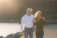 couple walking sunset engagement photos by the bay and golden gate bridge at cavallo point