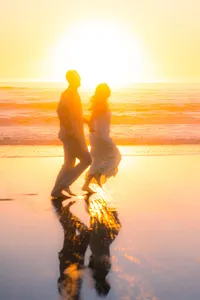 sunset beach couple running on sand barefoot in santa cruz