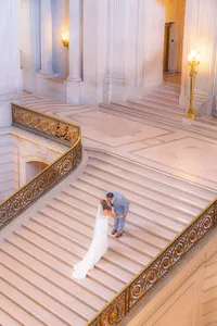 wedding couple kiss on stairs at san francisco city hall wedding