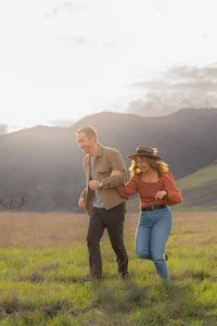 couple running engagement photos by mountains in clayton california