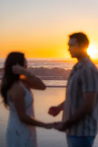 engagement couple running on beach together in santa cruz