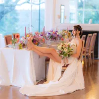 editorial bride sitting at tablescape drinking champagne at hollins house in santa cruz