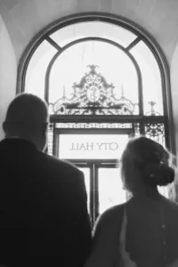 san francisco city hall wedding exit with city hall sign