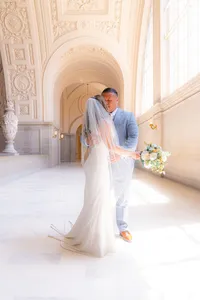 bride and groom posing at san francisco city hall wedding