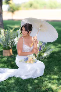 bride sitting with parasol under tree at rainbow oaks ranch in sanger california