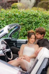 bride and groom sitting in classic car in santa cruz at hollins house