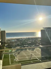 View from a Rock Royalty Ocean front room at Hard Rock Los Cabos taken at sunset shows a large terrace that is ideal for a large group, with ocean views in the background
