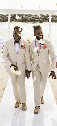bryan-preston-lgbtq-grooms-walking-aisle-destination-wedding-hard-rock-riviera-maya