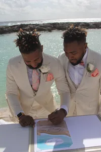 bryan-preston-two-grooms-signing-wedding-book-beach-hard-rock-riviera-maya