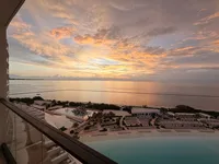 Oceanfront view at AVA Cancun in Mexico, with a glimpse of the lagoon pool and lounge chairs
