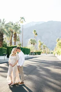 Outdoor photo of couple with palm tress during an outdoor maternity portrait session by Suzanne Karp Photography