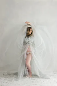 Pregnant woman in dramatic gown during luxury maternity portrait session by by Suzanne Karp Photography