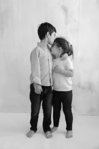 Black and white family photo of two siblings hugging by Suzanne Karp Photography in Marin California