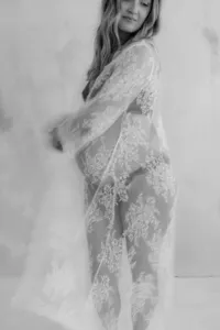 Candid motion blur photo of pregnant woman wearing lace dress during maternity photo session by by Suzanne Karp Photography