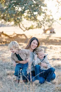 Mother and two kids on a field at a golden hour photo session by Suzanne Karp Photography in the Bay Area California