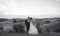 A newly married couple sharing an intimate moment during their Napa Valley wedding, set against rolling hills and vineyards in Wine Country California.