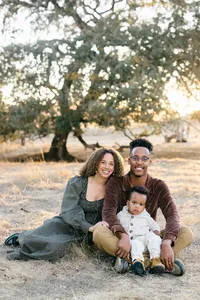 Family portrait at a golden hour outside laying on the grass by Suzanne Karp Photography in San Rafael California