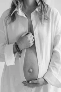 Black and white photo of pregnant woman during maternity portrait session by Suzanne Karp Photography