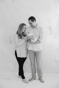 Mom, Dad and baby newborn in a black and white standing pose by Suzanne Karp Photography in the Wine County California