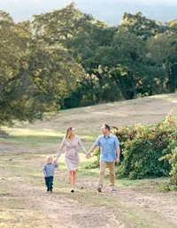 Couple and toddler walking outdoors at the golden hour by Suzanne Karp Photography in the Marin County California