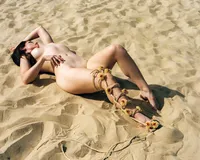 Woman photographed on film during an outdoor boudoir session at Jockey’s Ridge in North Carolina.