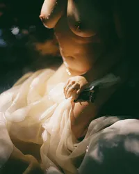 Woman photographed on film during a refined boudoir session in the Raleigh-Durham area.