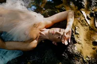 Fine art boudoir portrait photographed outdoors in nature on medium-format film.