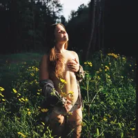 Woman photographed in natural light during a fine-art boudoir session near Durham, NC.